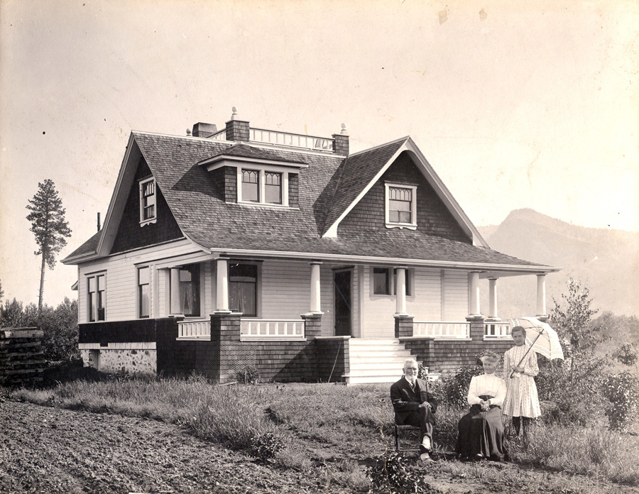 Alexander Leslie Fortune and his wife Bathia with a younger lady
standing in front of their home